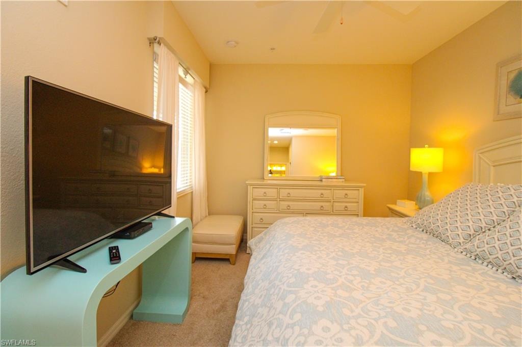 Bedroom featuring light carpet and ceiling fan