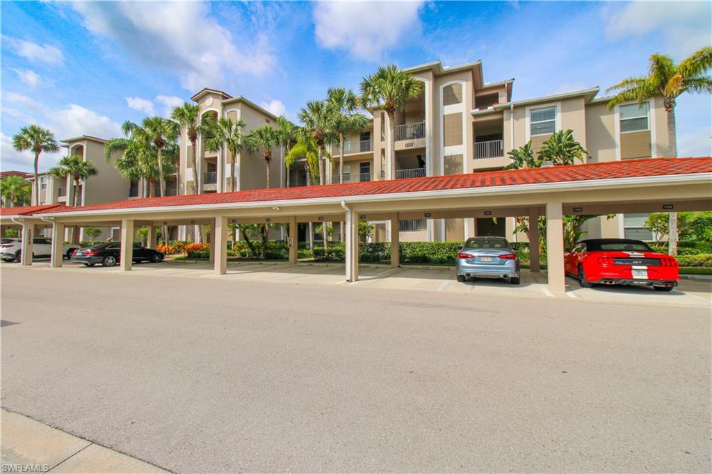 View of property with covered parking