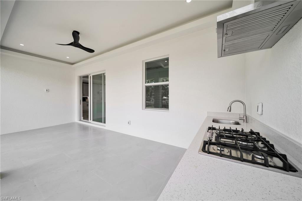 View of patio featuring ceiling fan and a sink