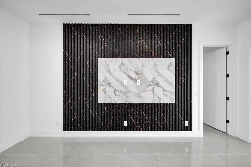 Detailed view of baseboards and an accent wall
