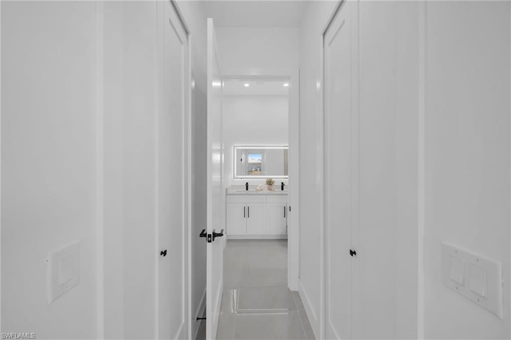 Corridor featuring light tile patterned flooring
