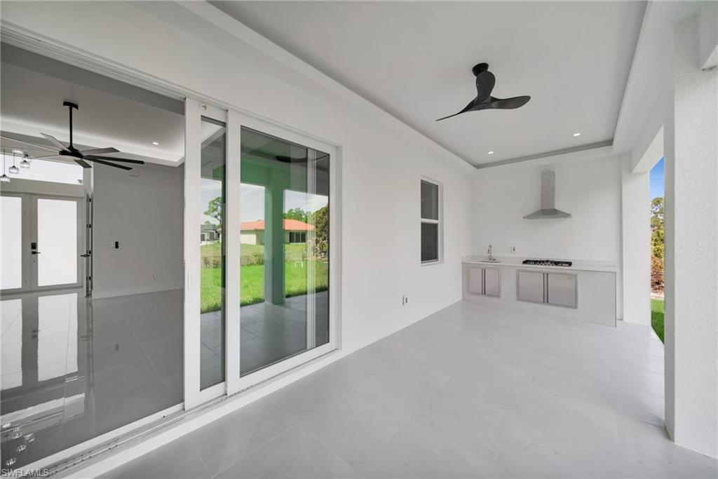 View of patio featuring ceiling fan and area for grilling