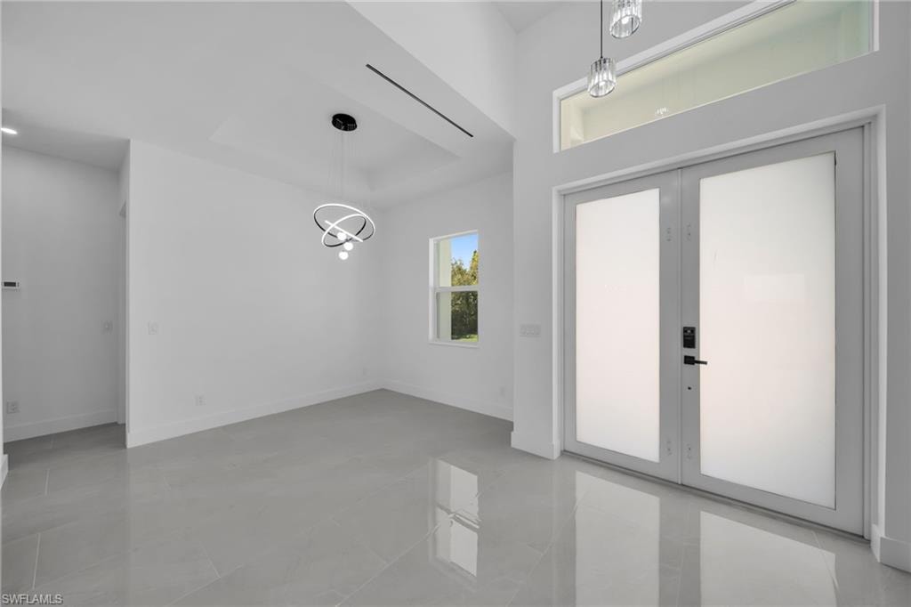 Entryway featuring french doors and hanging lights