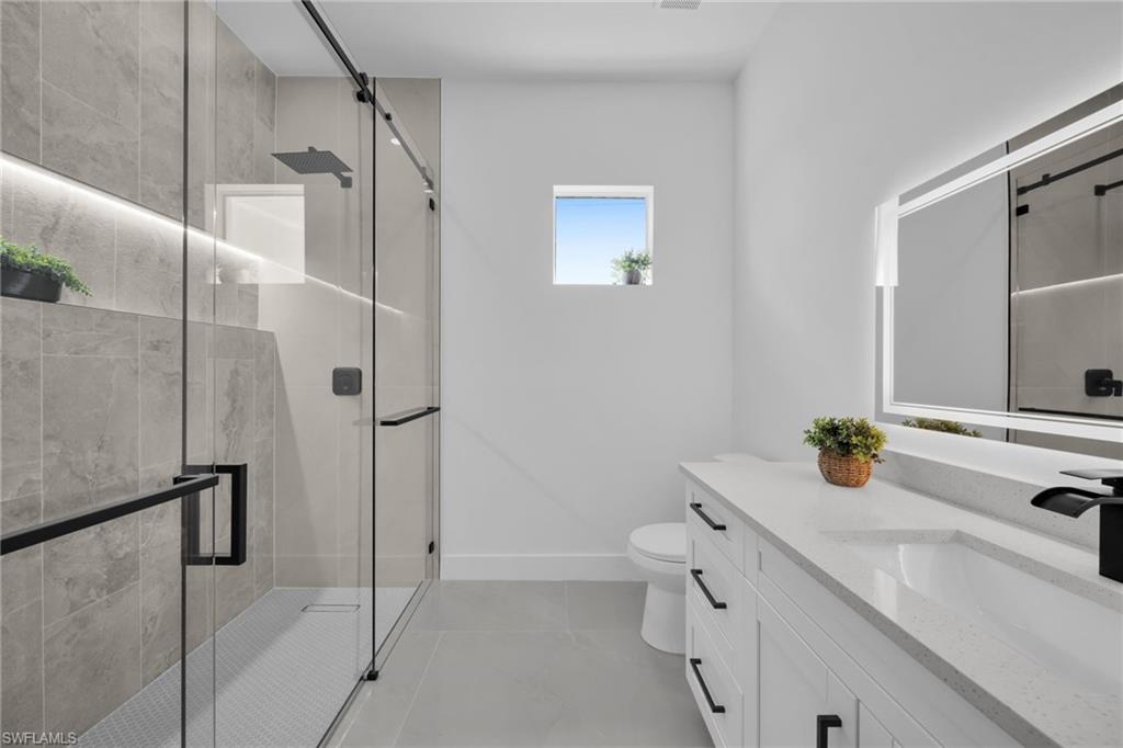 Bathroom featuring vanity and a stall shower