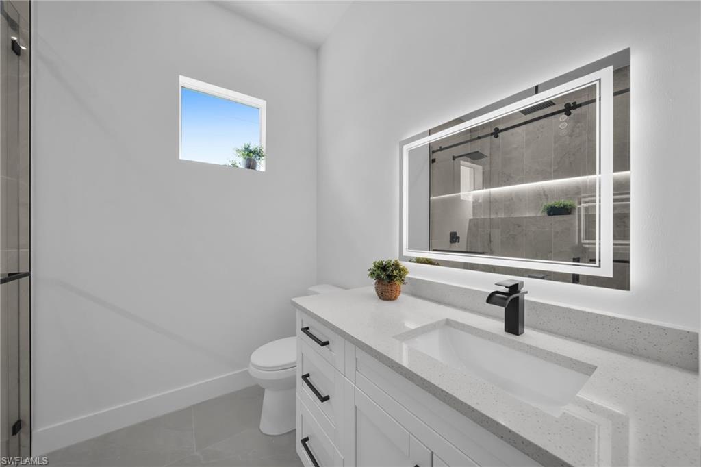 Full bathroom with vanity and a stall shower
