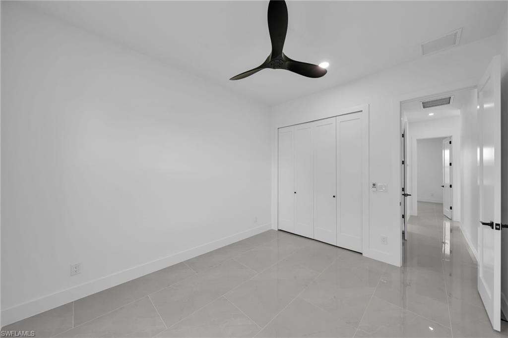 Unfurnished bedroom with a closet, a ceiling fan, and recessed lighting