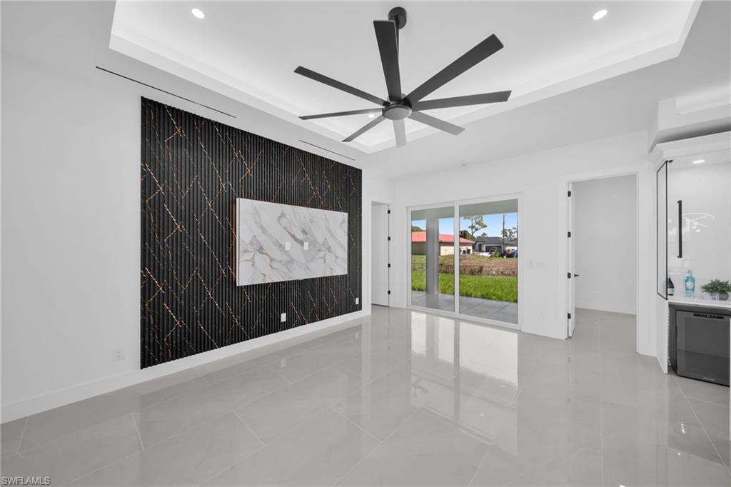 Unfurnished room featuring recessed lighting, a raised ceiling, and ceiling fan