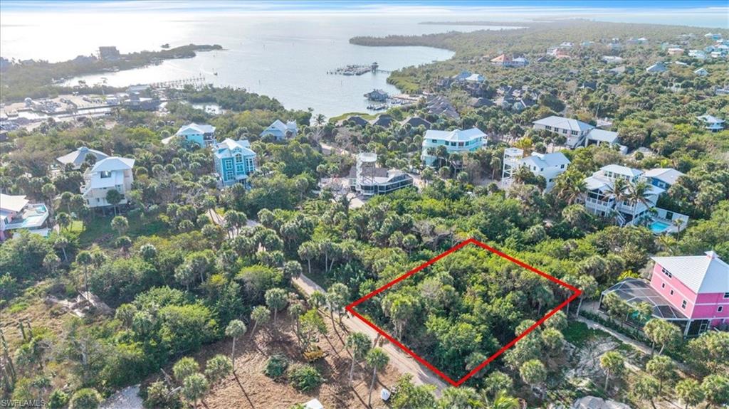 Aerial view of lot (outlined in red) with North Captiva's harbor and marina visible — boat in, step off, and walk home. Island life doesn't get more convenient than this.