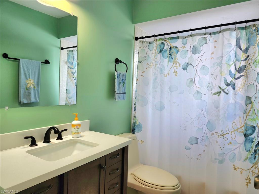 Guest bathroom has a linen closet located behind the door.
