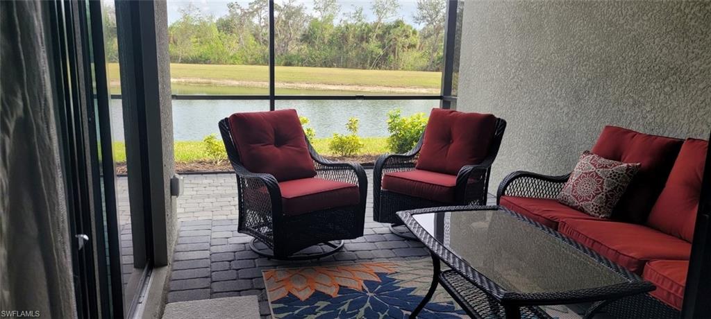 Sunroom featuring an outdoor lounge area and a water view