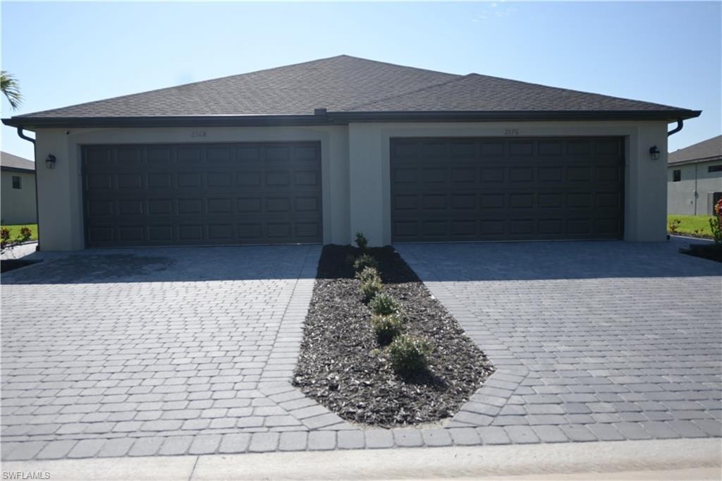 Garage featuring decorative driveway