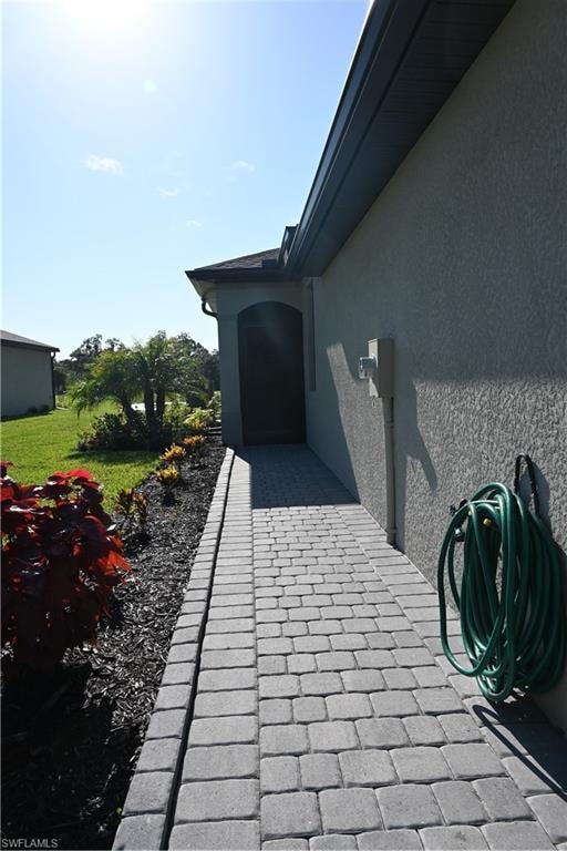Exterior view of stucco siding and Paver walkway