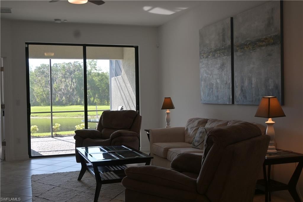 Living room featuring ceiling fan and tile patterned flooring