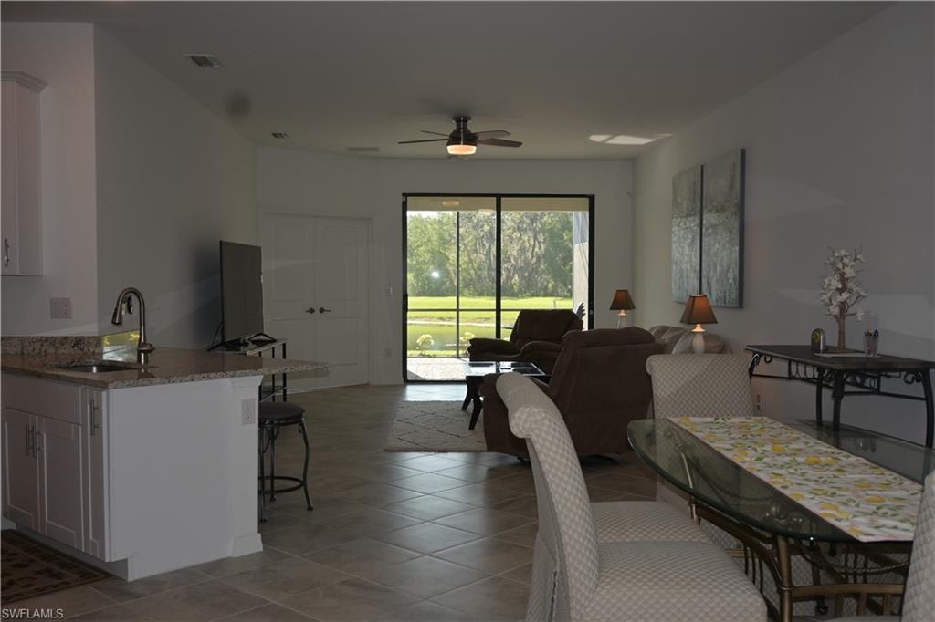 Dining area featuring ceiling fan and light tile patterned floors