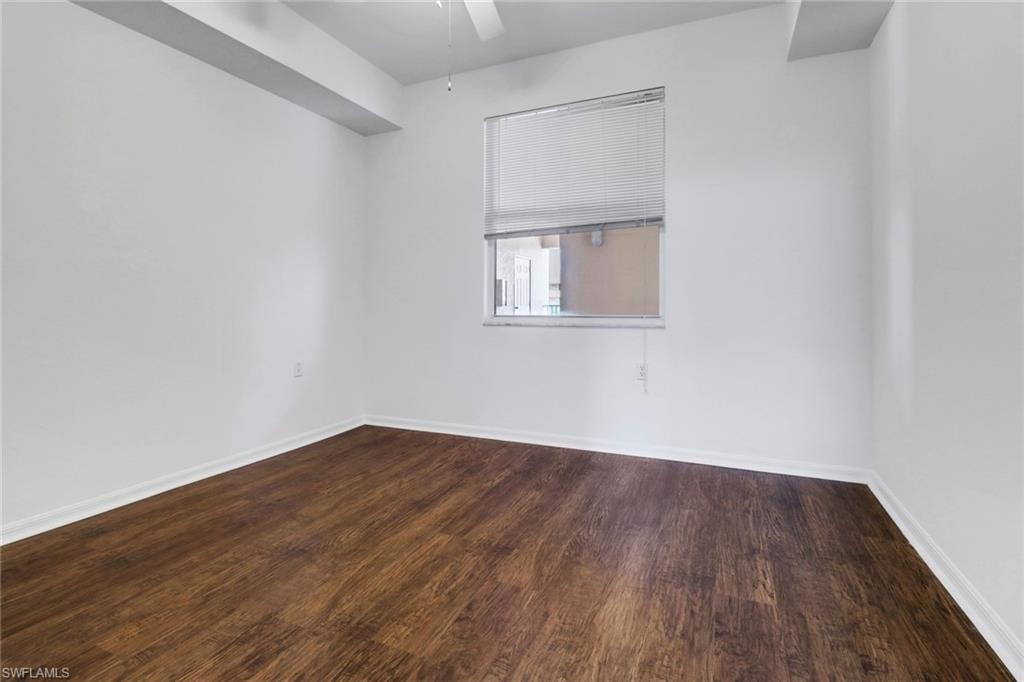 Unfurnished room with ceiling fan and wood-type flooring