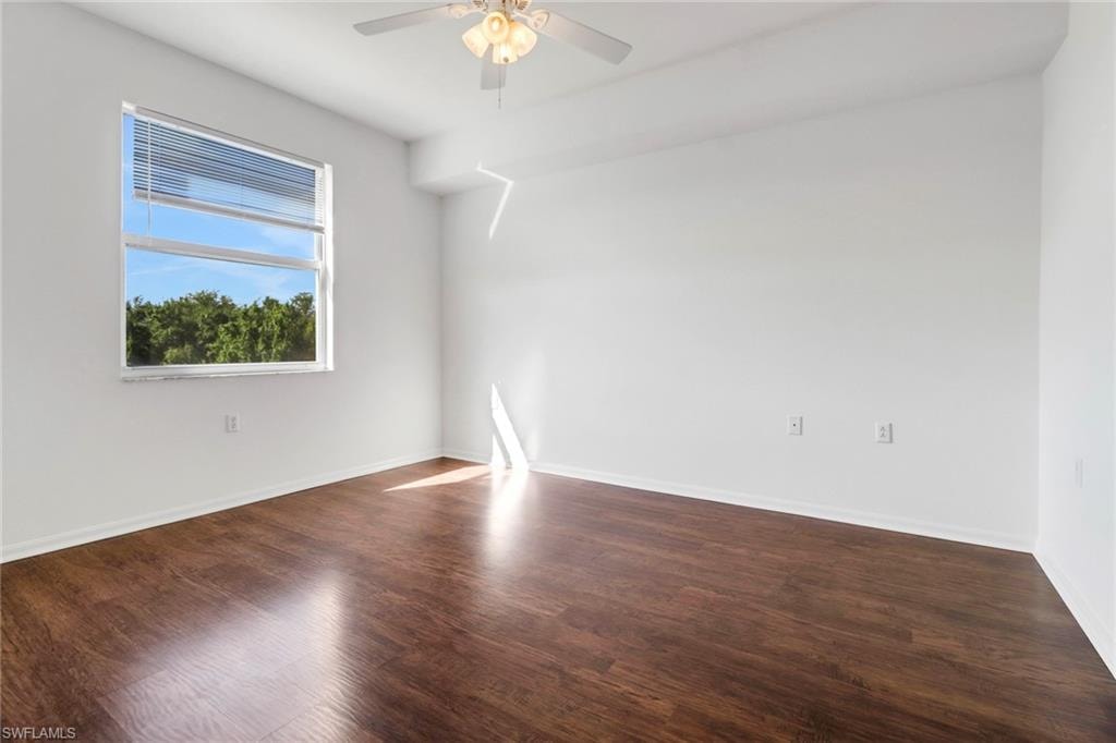 Spare room featuring hardwood / wood-style floors and ceiling fan