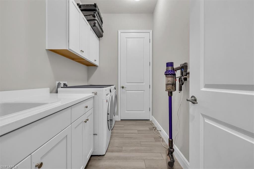 Laundry in back hallway with large walk in closet