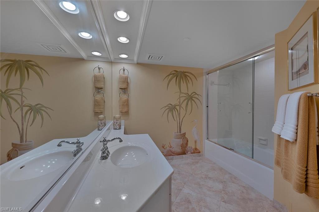 Full bathroom with vanity, bath / shower combo with glass door, and recessed lighting