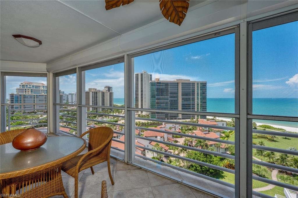 Sunroom / solarium featuring a city view and a water view