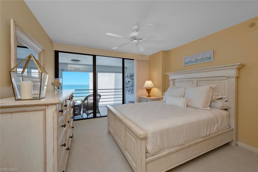 Bedroom with access to exterior, light carpet, and a ceiling fan