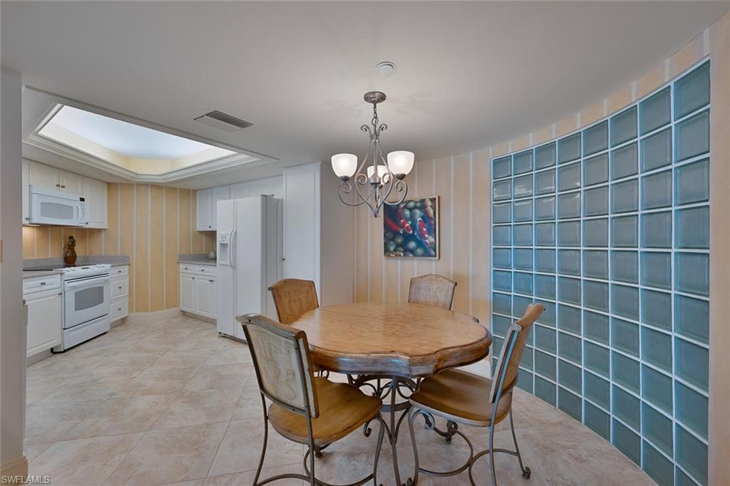 Dining area featuring suspended lighting and light tile patterned flooring