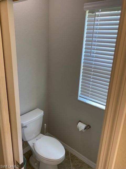 Bathroom featuring tile floors and toilet