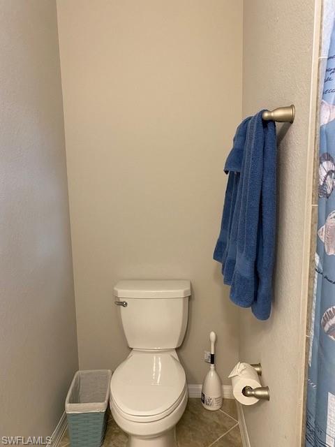 Bathroom featuring tile floors and toilet