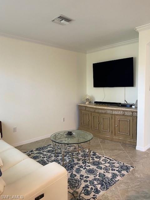 Living room with tile floors and ornamental molding