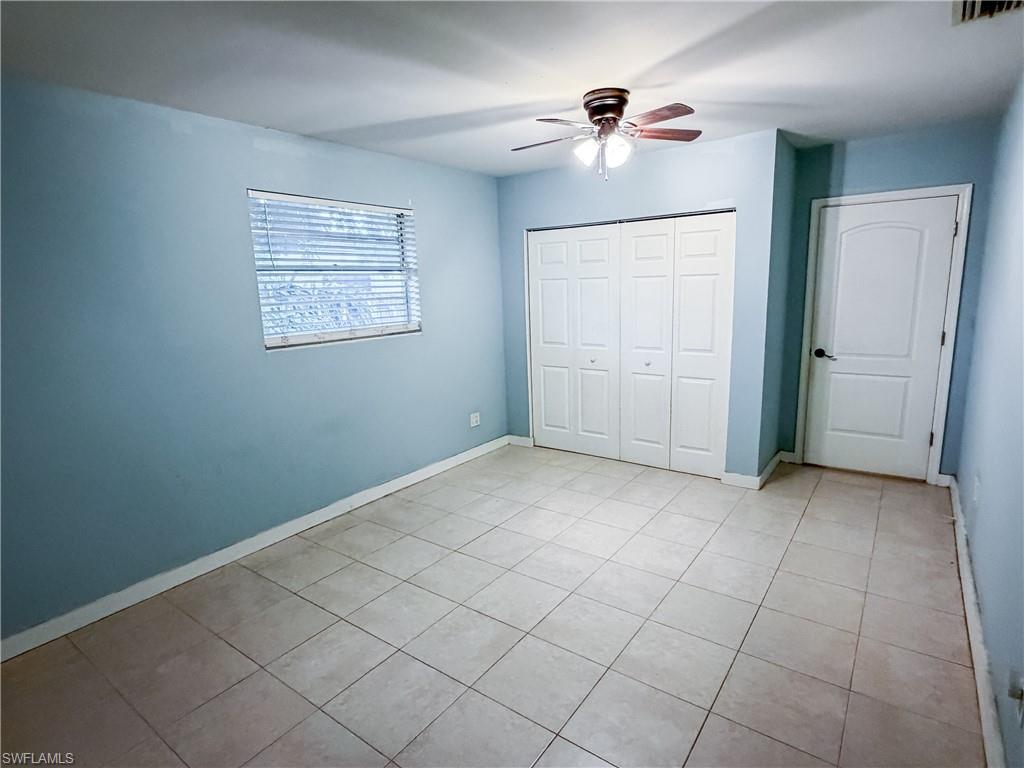 Guest Bedroom #3 featuring a ceiling fan, a textured ceiling, and light tile patterned floors