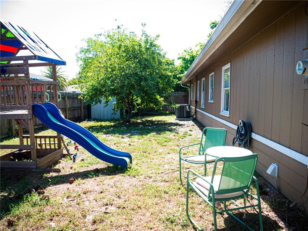 Large backyard featuring a playground