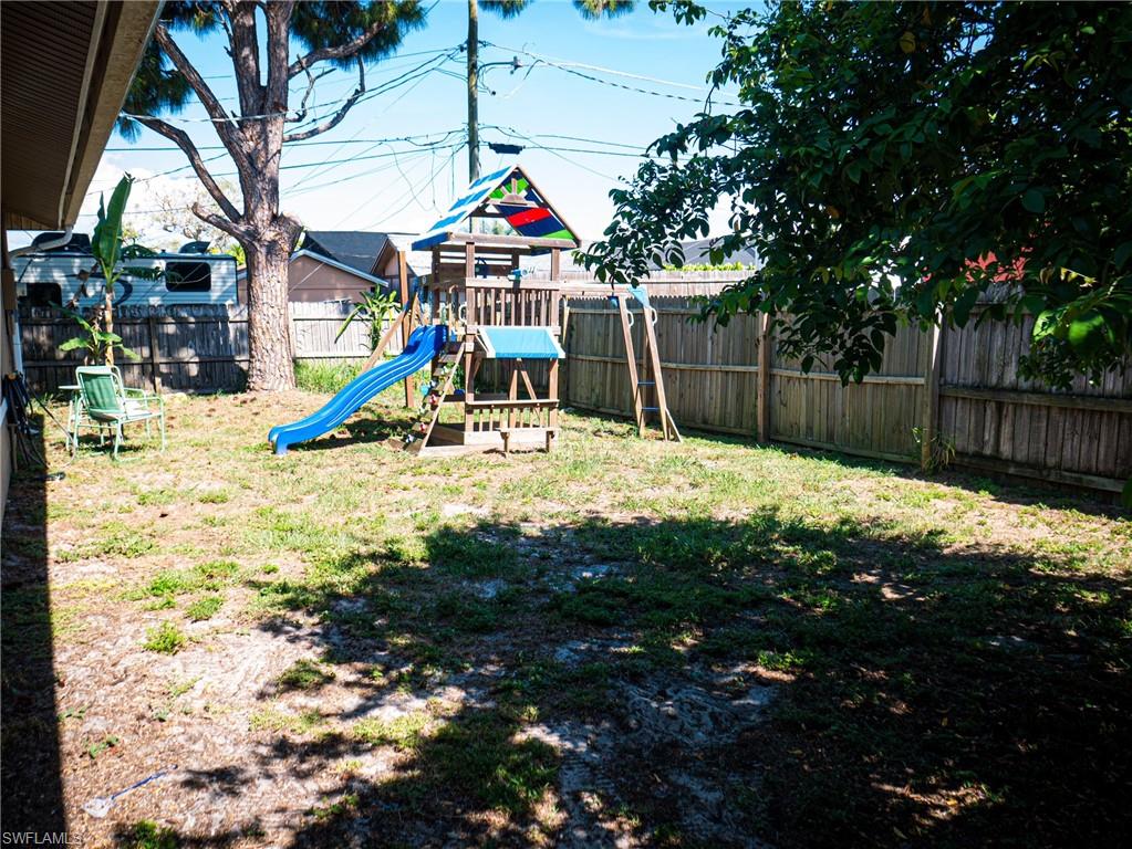 Large backyard featuring a playground