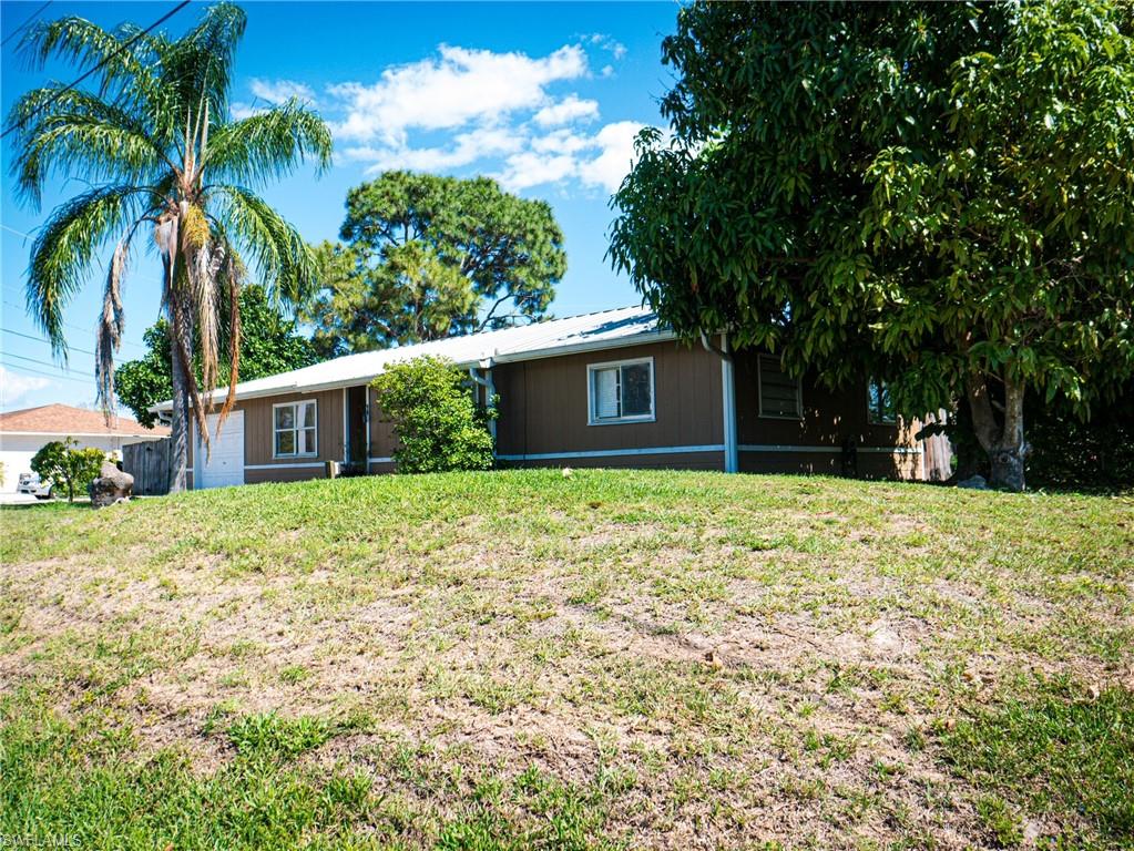 Ranch-style house featuring driveway and a metal roof