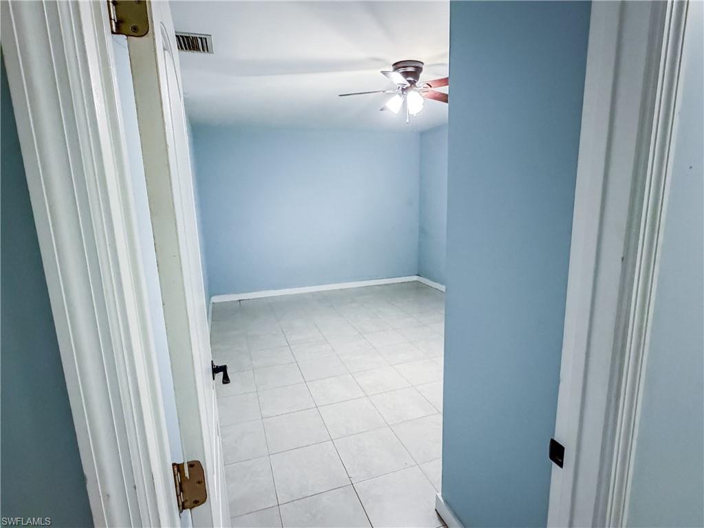 Guest Bedroom #3 featuring a ceiling fan, a textured ceiling, and light tile patterned floors