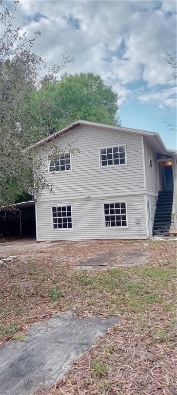 View of side of home with a carport