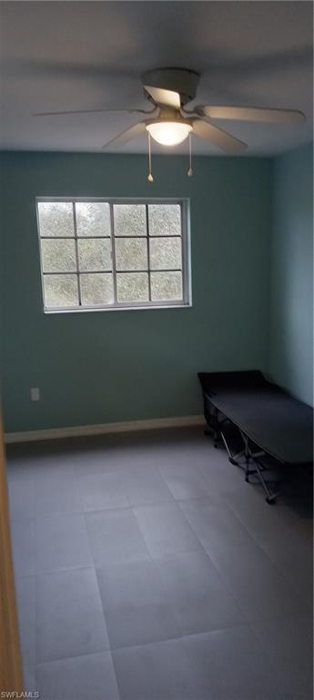 Unfurnished bedroom with baseboards and a ceiling fan