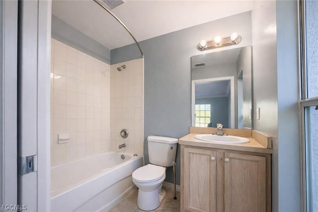 Bathroom with vanity,  shower combination, and light tile patterned floors