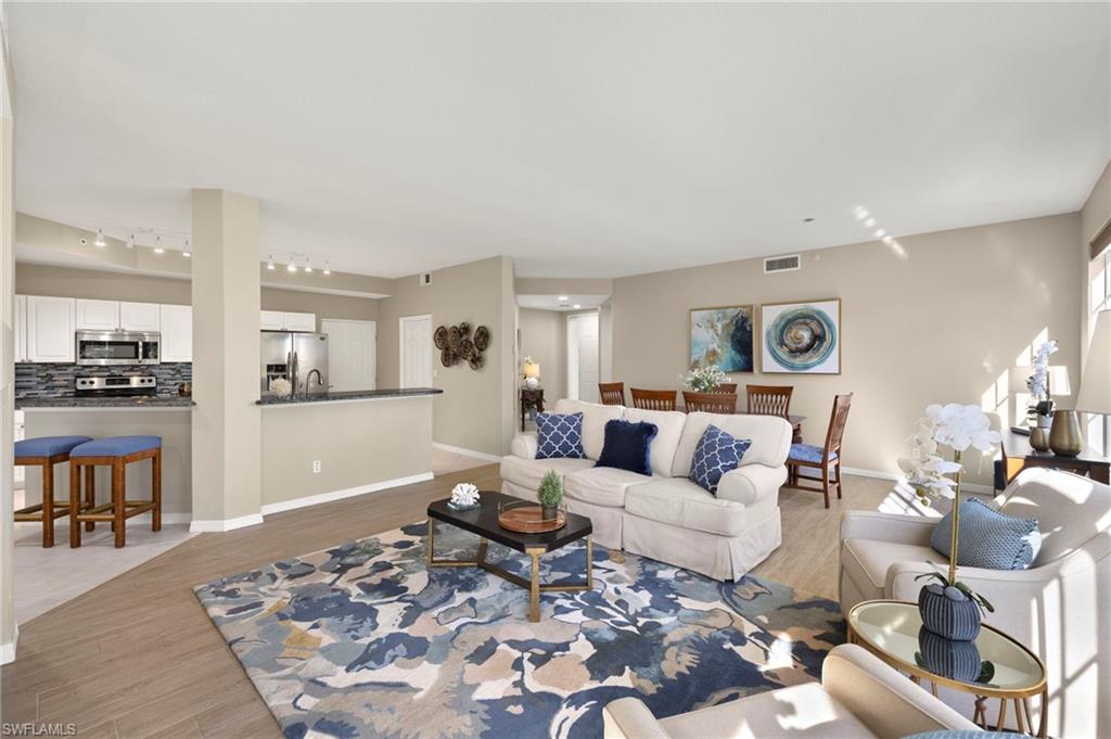 Living area featuring track lighting, light wood-type flooring, and baseboards