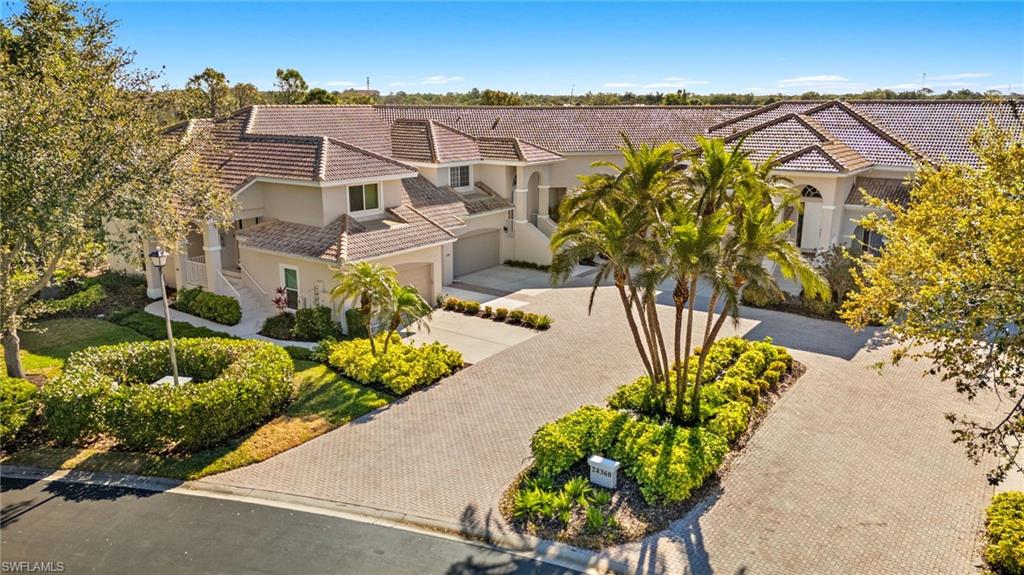 Mediterranean / spanish-style house with stucco siding, a garage, concrete driveway, and a tiled roof