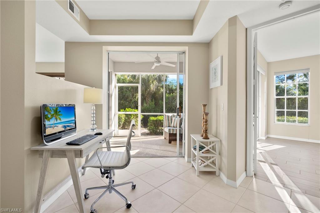 Office space featuring plenty of natural light, a ceiling fan, and baseboards