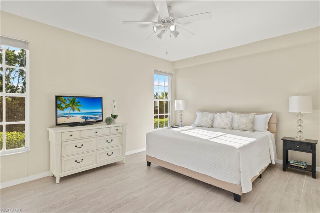 Bedroom featuring light wood-style flooring, baseboards, and ceiling fan