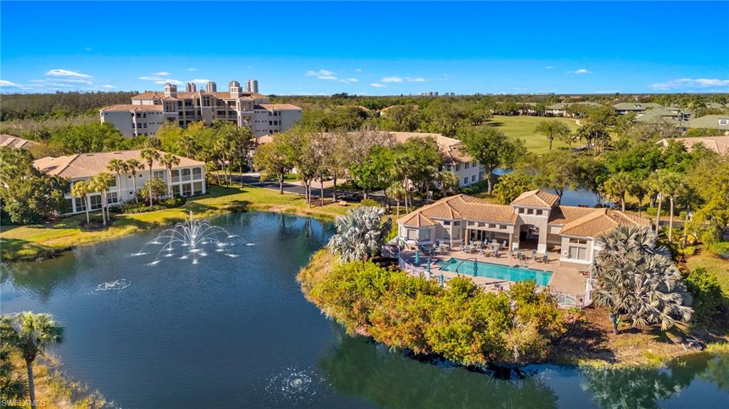 Bird's eye view of a nearby body of water and a pool
