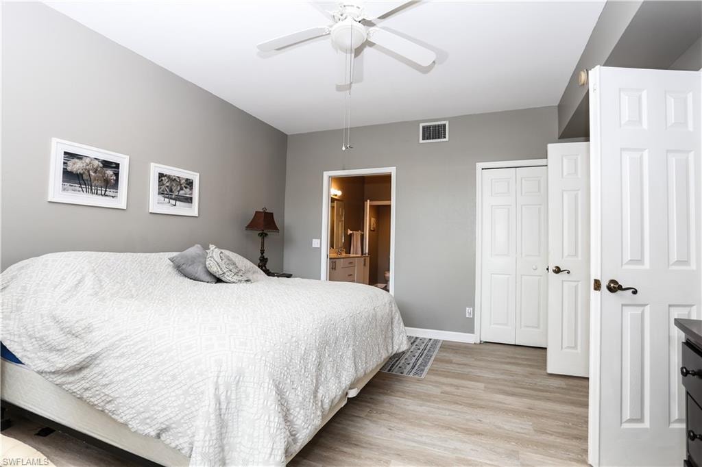 Bedroom featuring light wood-type flooring, ensuite bath, and ceiling fan