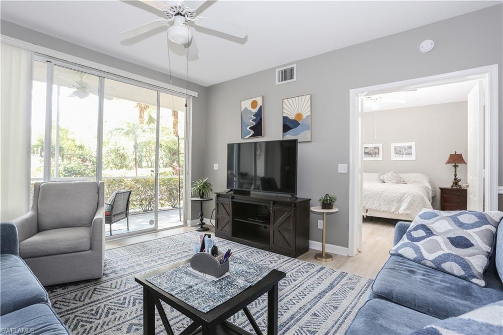 Living area with a ceiling fan and light wood finished floors