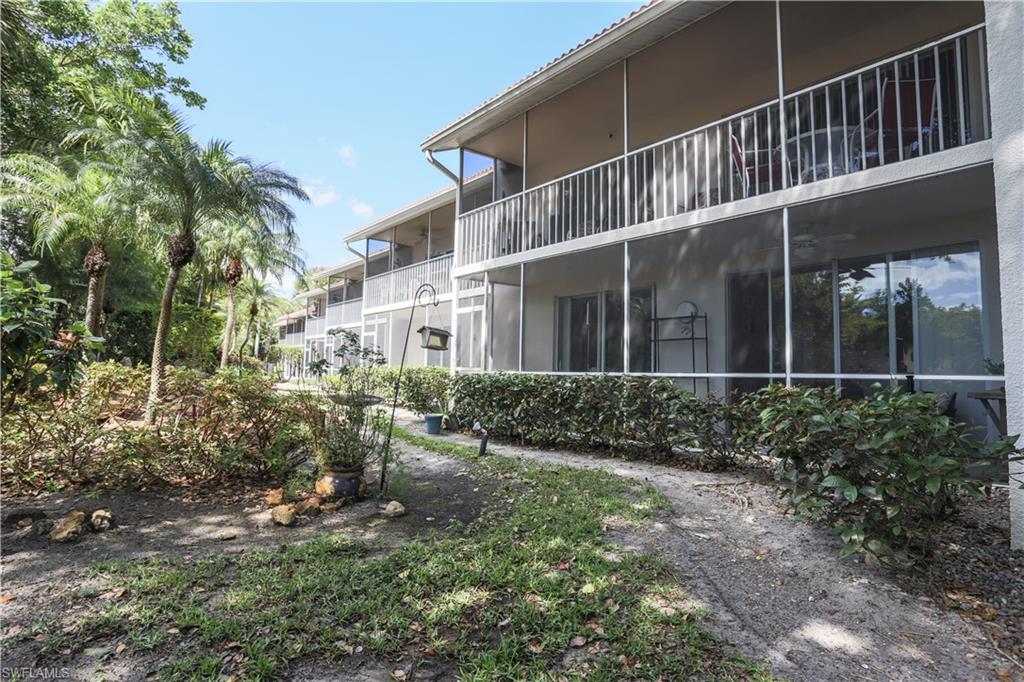 View of side of property featuring a sunroom, a balcony, and stucco siding