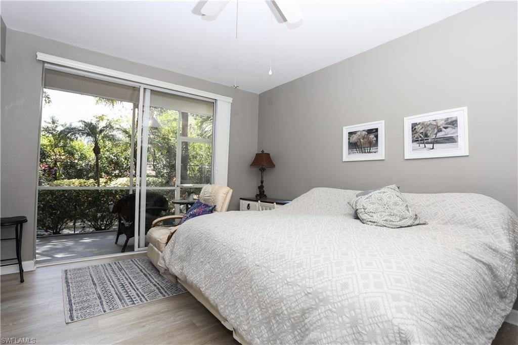 Bedroom with access to outside, light wood-style floors, and ceiling fan