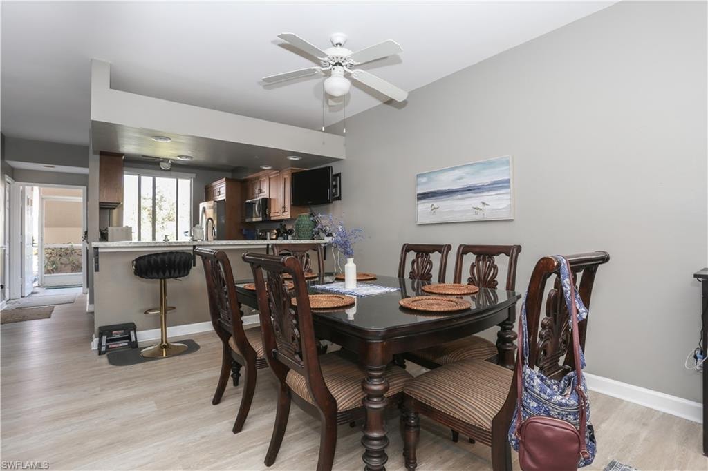 Dining space with light wood-style flooring and ceiling fan