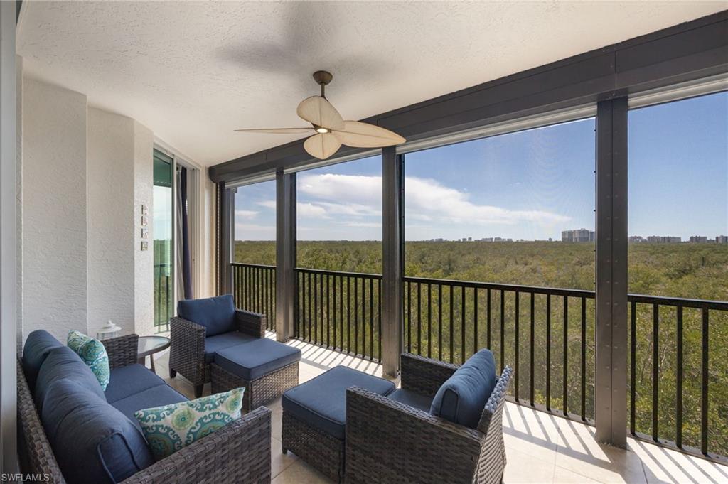 Sunroom with a ceiling fan, outdoor seating, and a balcony