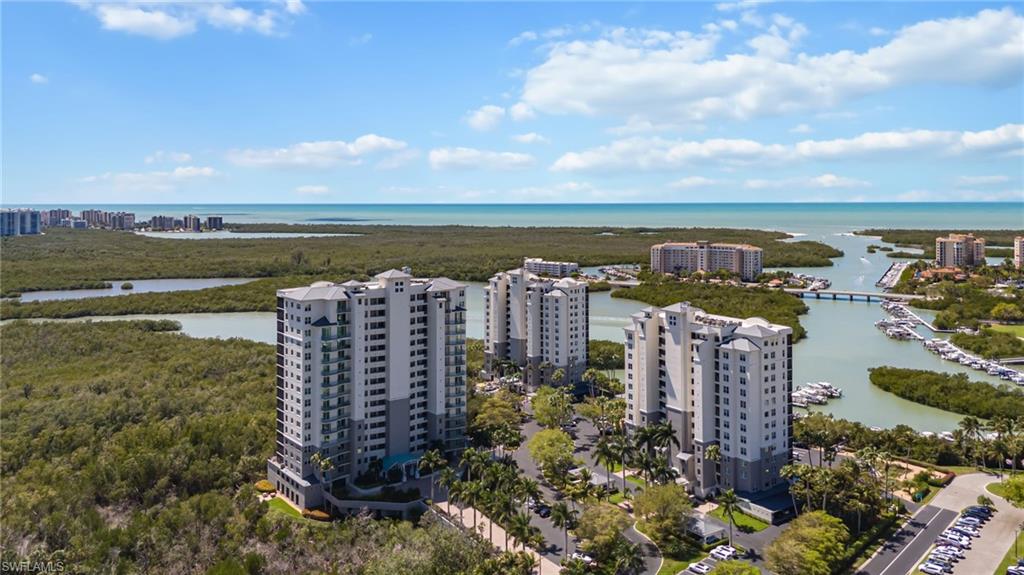 View of urban area featuring apartment complex and a nearby body of water