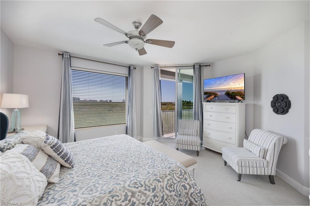 Bedroom featuring light colored carpet, access to outside, and ceiling fan