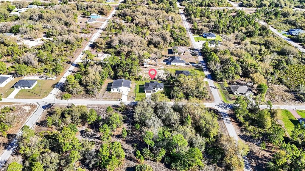 Aerial view of residential area featuring a tree filled landscape